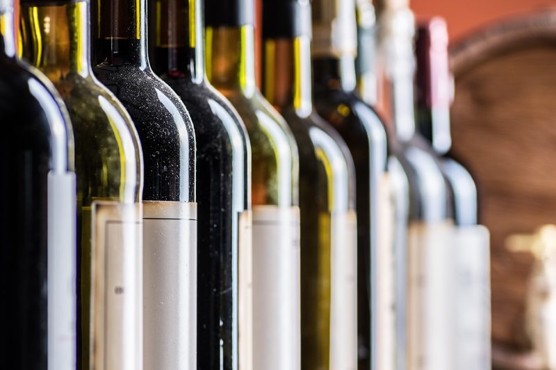 Wine bottles in row and oak wine keg.; Shutterstock ID 1051120241; Job (TFH, TOH, RD, BNB, CWM, CM): TOH